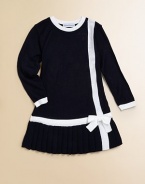 A precious knit, drop-waist design is updated with a pleated skirt and bow trim.CrewneckLong sleevesBack zipperDrop-waistPleated skirtAcrylicMachine washImported