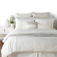 In subtle hues of gold and silver set against a cream ground, this Hudson Park king bedskirt combines elegant embroidery with a modern aesthetic. In subtle hues of gold and silver set against a cream ground, this Hudson Park king bedskirt combines elegant embroidery with a modern aesthetic.