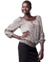 Make a sophisticated splash at work with this split-sleeve, smocked top from AGB.
