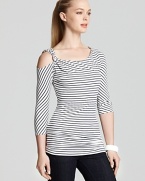 Infuse your daily repertoire with modern eclecticism in this VINCE CAMUTO top, sharply styled with graphic stripes and a racy cutaway shoulder.