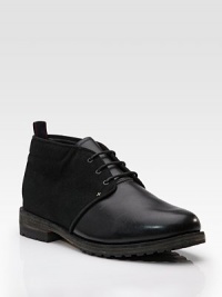 A low, ankle-high silhouette in two textures of leather, cross-stitched for premier style and timeless construction. Padded insole Gum vibram sole Imported A low, ankle-high silhouette in two textures of leather, cross-stitched for premier style and timeless construction. Padded insole Gum vibram sole Imported