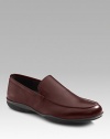 Soft calfskin slip-on has comfortable rubber sole with red stripe logo detail. Leather lining Padded insole Made in Italy 