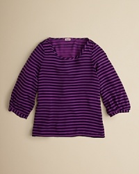 A loose-fitting tunic keeps the look relaxed with a scoop neckline, ruched sleeves and a high/low hemline. A loose-fitting tunic keeps the look relaxed with a scoop neckline, ruched sleeves and a high/low hemline.