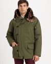 A modern interpretation of a classic style, this military style parka jacket exudes city-cool featuring zippered pockets on the sleeve and an attached faux-fur lined hood.Zip frontButton-front placketAttached faux-fur lined hoodWaist flap pocketsAbout 31 from shoulder to hemCottonDry cleanImported