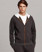 Full front zip hooded sweatshirt with split kangaroo pocket. Thermal, contrast lined hoodie. Orange trim detail at zipper.