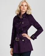 A sheer sheen and glimmering accents lend a glamorous finish to a black Juicy Couture trench coat.