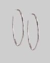 Delicate yet dramatic hoops of hammered sterling silver. Sterling silver Diameter, about 1¾ Post back Imported