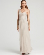 This wispy Amsale one-shoulder gown of rich silk hangs fluidly on the frame.