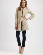 A refreshing take on a classic favorite, this design features luxurious leather trim and an ultra-feminine silhouette. Round neckButton frontLeather trimBelted designAbout 35 from shoulder to hemFully lined50% cotton/50% nylonDry cleanImported