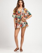A breezy coverup with a vivid floral print. V-neckFlutter sleevesEmpire waistSelf-tieCottonDry cleanImported