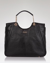 Salvatore Ferragamo's luxurious leather tote with signature Gancio buckle ornaments is the perfect sophisticated silhouette for your everyday essentials. Salvatore Ferragamo's luxurious leather tote with signature Gancio buckle ornaments is the perfect sophisticated silhouette for your everyday essentials.