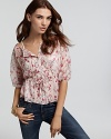 GUESS lends a breath of fresh air to your wardrobe in this floral peasant top. Pair with jeans and flats for a relaxed weekend look.