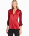 A shimmering body and matte sleeves (as well as a crisp, modern neckline) make this T Tahari blouse stunning.