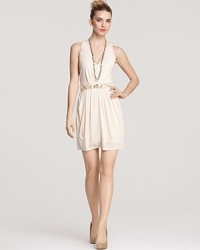 Akiko's V-neck dress is a chic choice for summer. A hardware-bedecked elastic belt finishes the look with striking style. Akiko's V-neck dress is a chic choice for summer. A hardware-bedecked elastic belt finishes the look with striking style.