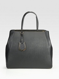 A roomy style in luxurious leather and matching coated twill with signature hardware.Double coated twill top handles, 6¼ dropSnap strap closure with center claspProtective metal feetOne inside zip pocketFully lined15W X 13½H X 6½DMade in Italy A roomy style in luxurious leather and matching coated twill with signature hardware.Double coated twill top handles, 6¼ dropSnap strap closure with center claspProtective metal feetOne inside zip pocketFully lined15W X 13½H X 6½DMade in Italy