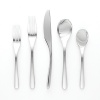 Aura five-piece place setting by Nambé. Made of forged 18/10 stainless steel and polished to a mirror finish, these pieces are exceptionally lustrous, durable and rust resistant. Setting consists of dinner fork, salad fork, knife, teaspoon, and tablespoon.