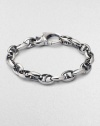 Bold oval links of polished sterling silver have not-so-sinister curved spikes in their centers.Sterling silver Length, about 8½ Lobster clasp Imported