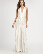 This sexy silk style features a plunging halter neckline and a dramatically ruffled front drape.Plunging halter necklineSleevelessRuffled front drapeTiered skirtBack strap with hook-and-eye closureConcealed back zipFully linedAbout 45 from natural waistSilkSpot cleanImportedModel shown is 5'11 (180cm) wearing US size 4. 