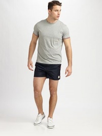 Don't hit the sun or sand without these solid swim trunks with stripe detail, set in quick-drying nylon.Snap button closureElastic waistSide slash, back flap pocketsInseam, about 5Cotton/nylonMachine washImported Don't hit the sun or sand without these solid swim trunks with stripe detail, set in quick-drying nylon.Snap button closureElastic waistSide slash, back flap pocketsInseam, about 5Cotton/nylonMachine washImported