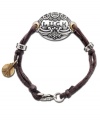 Keep good luck on your side with this charmingly rustic bracelet by Lucky Brand. Brown wax cord holds a medallion engraved with the word LUCK and a peace sign. Crafted in silver tone mixed metal. Approximate length: 7-1/2 inches.