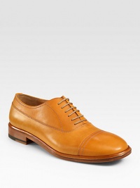 An extraordinary oxford design gets a modern update, rendered in a smooth, vibrant leather with stitching and captoe detail.Leather upperLeather liningPadded insoleLeather soleMade in Italy An extraordinary oxford design gets a modern update, rendered in a smooth, vibrant leather with stitching and captoe detail.Leather upperLeather liningPadded insoleLeather soleMade in Italy