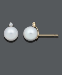 The perfect touch of elegance and timeless style. These simple stud earrings feature polished cultured freshwater pearls (8-9 mm) accented by a single sparkling diamond accent. Crafted in 14k gold. Approximate diameter: 5/8 inch.
