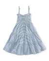 A stylish striped jersey dress is updated with smocked detailing and a pretty flared silhouette.