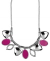 A colorful infusion. Nine West's pretty necklace features leaf-shaped charms and fuchsia enamel ovals for a bright pop of color. Set in silver tone mixed metal. Approximate length: 16 inches + 2-inch extender. Approximate drop length: 1 inch. Approximate drop width: 5-3/4 inches.