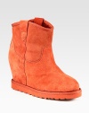 Practical and fashion-forward suede boot, lined with shearling and heightened by a hidden wedge. Suede-covered heel, 3½ (90mm)Rubber platform, ¾ (20mm)Compares to a 2¾ heel (70mm)Shaft, 7Leg circumference, 11Suede upper with grosgrain trimPull-on styleShearling liningRubber solePadded insoleImported