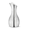 The Georg Jensen Legacy collection is a perfect illustration of how a more decorative style incorporated into modern design can result in a gorgeous piece - the smooth, curved surfaces are mirroring their surroundings in a world of glittering sumptuousness. The Georg Jensen Legacy pitcher is ideal for pouring water or juice, for example. The decorative grooves provide a firm grip while the pitcher insulating design ensures that ice water stays cold for a while. The Georg Jensen Legacy pitcher is made of stainless steel and comes with an elegant white stopper.