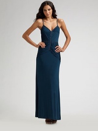 This gorgeous, textured design with gentle gathers is highlighted by stunning, beaded trim at the bodice. Sleeveless Adjustable straps V neckline Side zipper About 44½ from natural waist Polyester/spandex; dry clean Imported This gorgeous, textured design with gentle gathers is highlighted by stunning, beaded trim at the bodice. Sleeveless Adjustable straps V neckline Side zipper About 44½ from natural waist Polyester/spandex; dry clean Imported