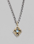 Chic little blossom accent in gleaming sterling silver and 18k gold, centered with a smooth cabochon blue topaz stone. Chain sold separately About ½W X ¾H Imported