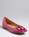 In high-polish leather with distinctive logo accents, these flats are fabulously Salvatore Ferragamo.