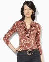Rendered in a lightweight cotton knit, a soft top features a tiered ruffle trim along the neckline for feminine charm.