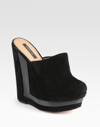 Soft suede design with wooden inserts and an architectural wedge and platform. Stacked suede and wooden wedge, 5¾ (145mm)Stacked platform, 1¾ (45mm)Compares to a 4 heel (100mm)Suede upperLeather lining and solePadded insoleImportedOUR FIT MODEL RECOMMENDS ordering one half size up as this style runs small. 