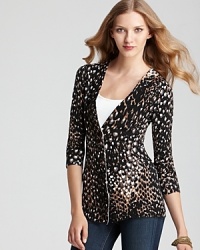 Cozy up for fall in this formfitting Trina Turk sweater, touting an exotic animal print. Cozy up for fall in this formfitting Trina Turk sweater, touting an exotic animal print.