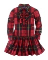 The essential shirtdress is rendered in a preppy plaid design with pretty ruffles.