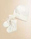 Adorable baby's hat and bootie set knit in luxurious, ultra-soft cashmere. Hat Ribbed, foldover brimCinched top Booties Foldover ankle cuff with tie closureCashmereDry cleanImported