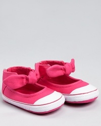 This cute starter sneaker gathers around the ankle for support and easy on/off, while the bow detail adds a touch of charm. This cute starter sneaker gathers around the ankle for support and easy on/off, while the bow detail adds a touch of charm.