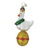 The golden goose sits atop an elaborately decorated golden egg.