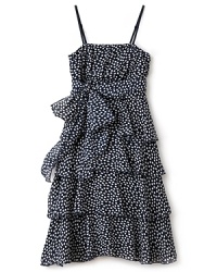 Un Deux Trois indulges a romantic look in ruffles, decked out with multiple tiers in polkadot print and an oversized bow tie at the right hip. Un Deux Trois indulges a romantic look in ruffles, decked out with multiple tiers in polkadot print and an oversized bow tie at the right hip.
