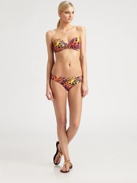 A tropical-hued animal print meets a timeless swim design. Plus, molded cups add shape and optional straps offer support.Bandeau topMolded cupsRemovable halter strapChic center detailBack tie closureFully lined92% nylon/8% spandexHand washImported Please note: Bikini bottom sold separately. 