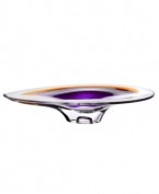 With the extraordinary beauty and grace of an orchid blossom, this Kosta Boda platter adds brilliant artistry to modern interiors. Luxurious art glass hand-crafted in a wide, fluid shape glistens with streaks of rich violet and warm amber.
