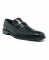 Calvin Klein puts some subtle sophistication in your men's dress shoes step with the sleek leather design and polished metal hardware of these slip-on men's loafers.