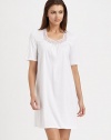Embroidered geometric shapes adorn the neckline of this ultra-soft silhouette with feminine ruching. Sweetheart necklieShort sleevesTulle and lace embroidery at the necklineFront ruchingAbout 35 from shoulder to hemBody: mercerized cottonLace: polyesterMachine washImported