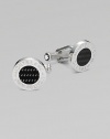 Polished sterling silver cuff links with round carbon center and logo detail.BrassAbout ½ diam.Imported