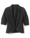 A menswear-inspired blazer with three-quarter shirred sleeves for a sophisticated look.
