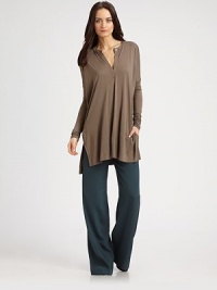 Lengthy tunic has a buttoned v-neck, long dolman sleeves and exaggerated hi-low hem. V-neck with button closureDropped shouldersLong dolman sleevesSide slits at hemHi-low hem hits below the hipsRayonDry cleanImportedModel shown is 5'10 (177cm) wearing US size Small. Lengthy tunic has a buttoned v-neck, long dolman sleeves and exaggerated hi-low hem. V-neck with button closureDropped shouldersLong dolman sleevesSide slits at hemHi-low hem hits below the hipsRayonDry cleanImportedModel shown is 5'10 (177cm) wearing US size Small.
