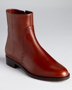 A classic boot with tonal top-stitched details elevates daily style. From Salvatore Ferragamo.