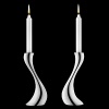 Georg Jensen Cobra candleholders in polished stainless steel. Designed by Constantin Wortmann, who took the familiar silhouette of the traditional candleholder and reinvigorated it with organic curves. It's snakelike strength is shared by its' name.